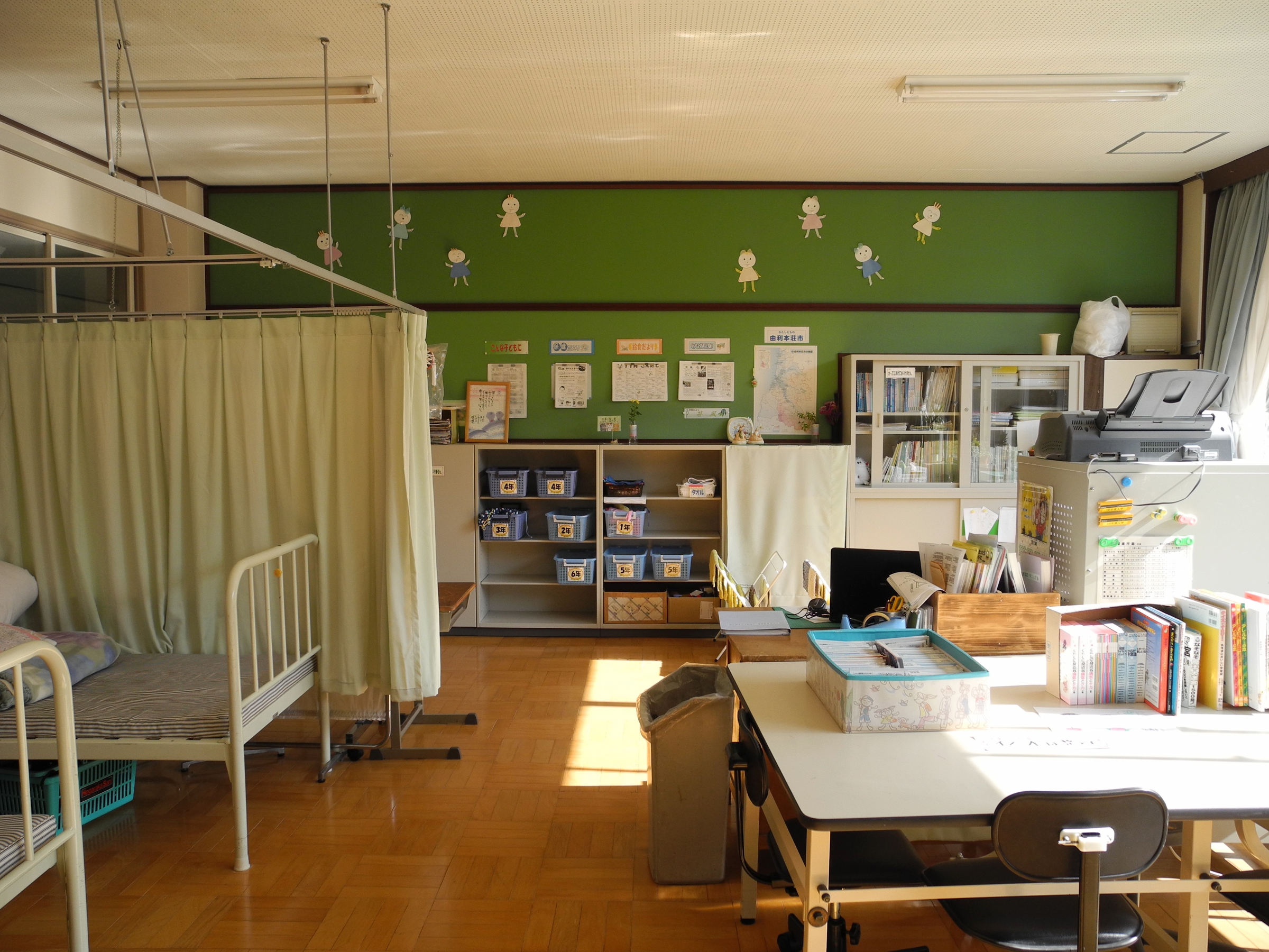 A school sickbay with a bed and curtain